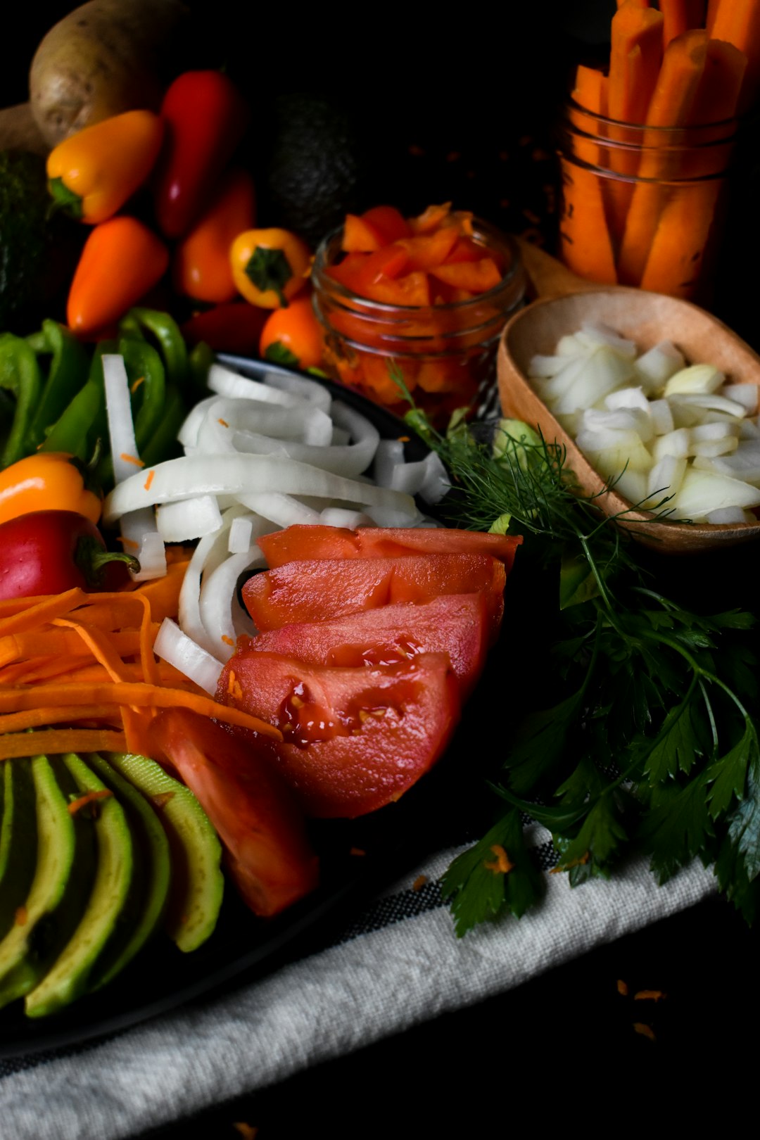 Carrots, peppers, potatoes, avocado, herbs, tomatoes, onions